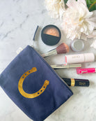 Navy canvas makeup bag with metallic gold foil horseshoe and Not My First Rodeo design