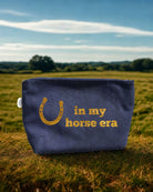 Navy canvas makeup bag with metallic gold foil horseshoe and In My Horse Era design